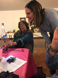 Pam Rice admires Cathy’s tiny art creation “Bats in a bottle”.jpeg